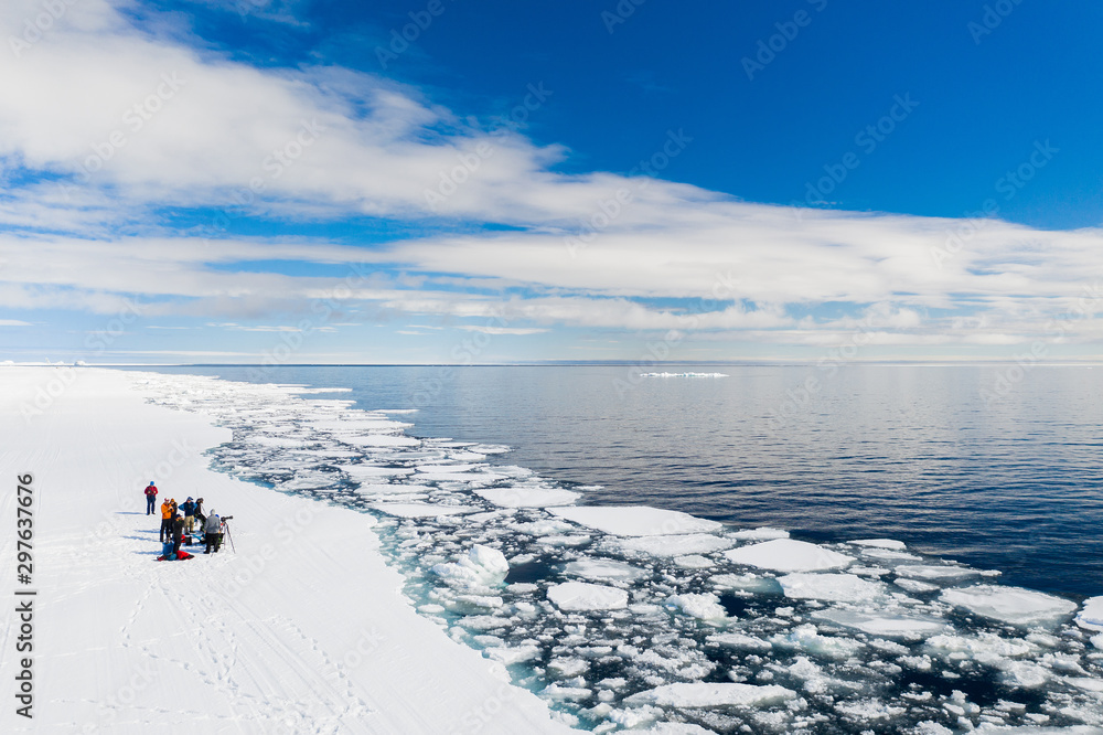 Aerial drone photo of tourists visit the floe edge near Sirmilik National Park in Nunavut, Canadaa