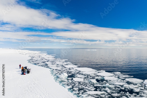 Aerial drone photo of tourists visit the floe edge near Sirmilik National Park in Nunavut, Canadaa photo