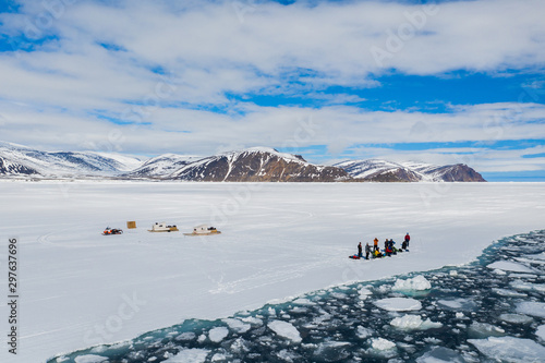 Aerial drone photo of tourists visit the floe edge near Sirmilik National Park in Nunavut, Canadaa photo