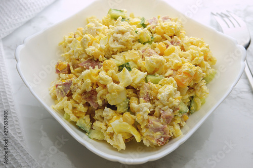 Salad of pasta, bacon, corn, eggs and cucumber