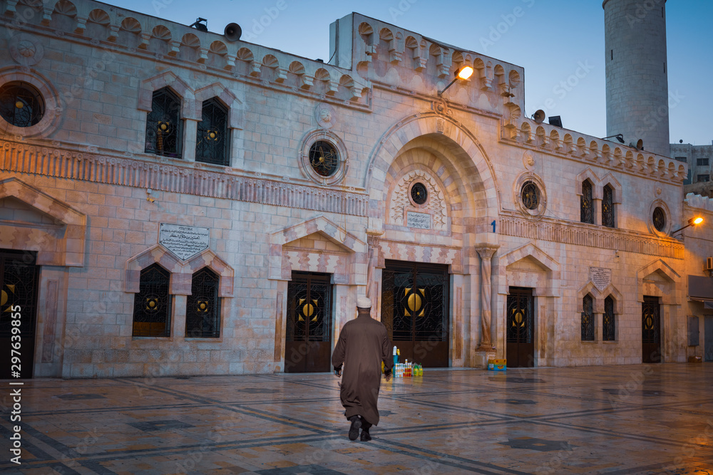 Worshiper walking to Al-Husseini Mosque  at early morning, Amman, Jordan