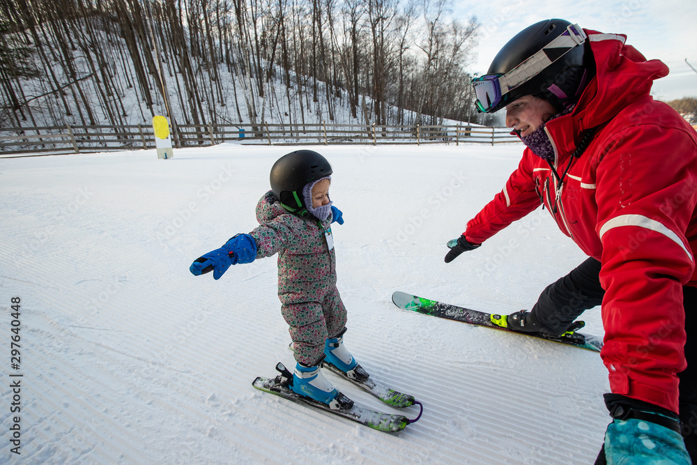 Young girl takes a skiing lesson
