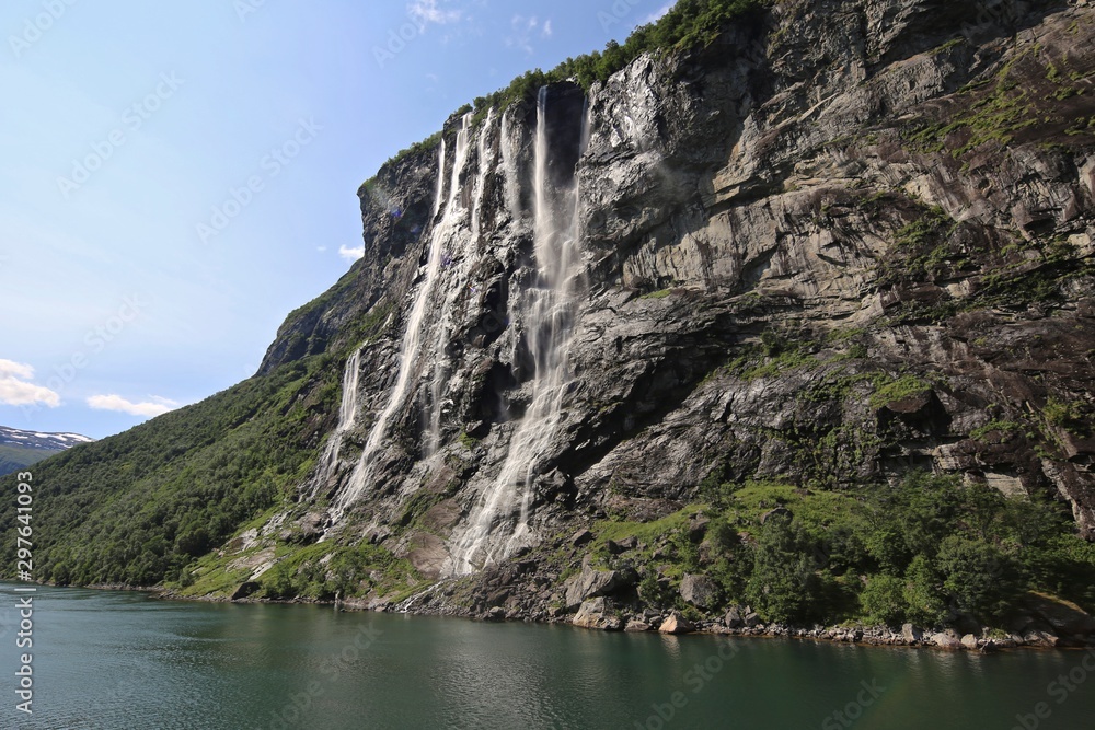 Views of the rocky and waterfall lined shores along the fjords of Norway