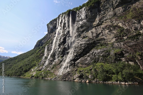 Views of the rocky and waterfall lined shores along the fjords of Norway