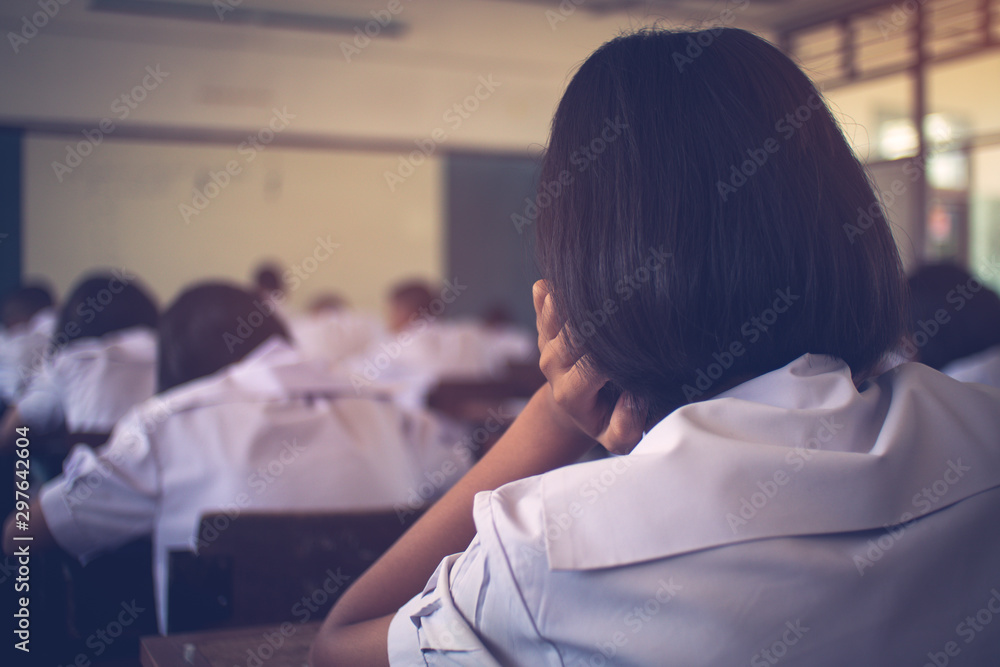 Students taking exam with stress in school classroom Students taking exam with stress in school classroom