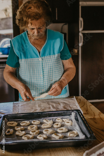 lady or grandmother preparing christmas candy or cakes photo