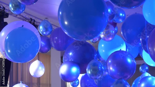 Festive accessories: Balloons on a background of light music. a lot of balloons. Party light music in nightclub lights, festive party atmosphere, fun. Concept of night party. Slow motion 