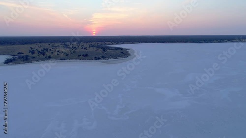 Aerial descend above beautiful salt lake at dusk in Australian desert photo