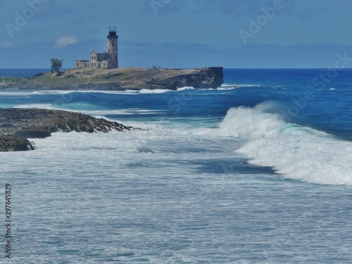 lighthouse on rock in sea