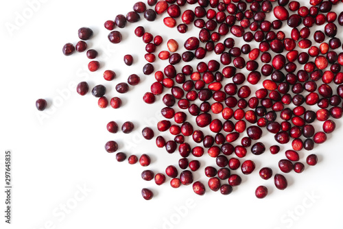 Cranberries. The scattered berries on white background. Fresh ripe red organic cranberries on white, directly from above, close up