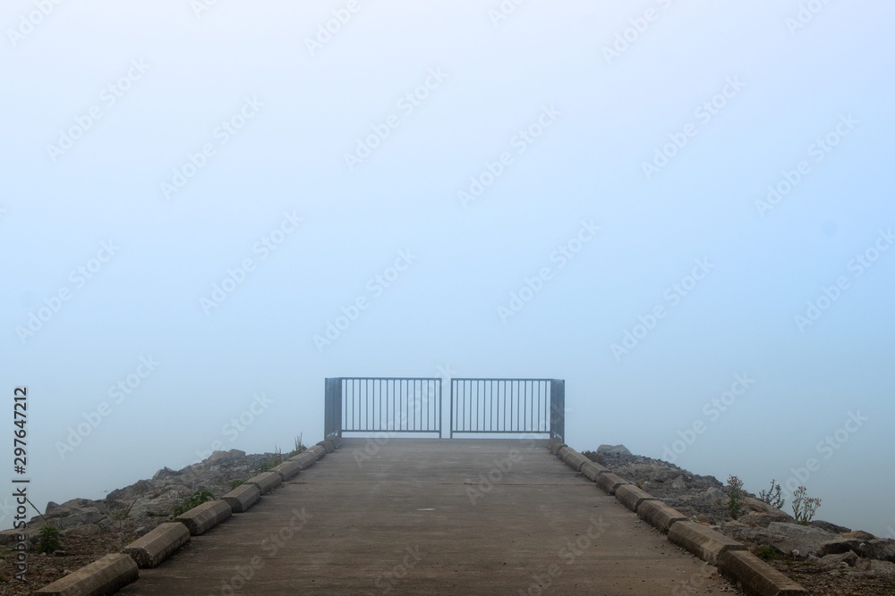 Isolated gate leading into foggy background Isolated gate leading into foggy background