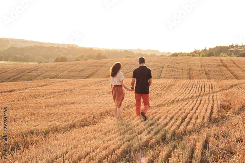 married couple walking in the field