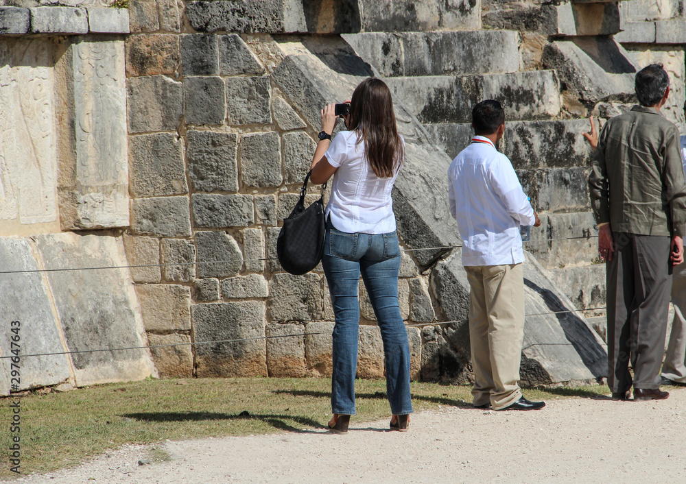 Tourists on the background of the ancient Mayan ruins