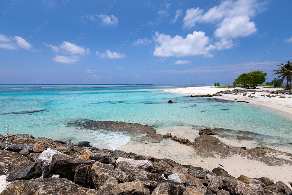 Tropical beach with rolling waves on rocks stones. Travel destination with nobody