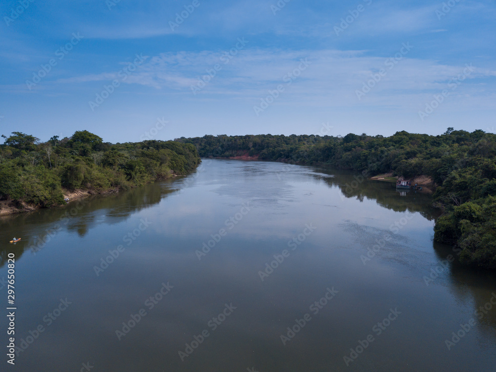 Beautiful aerial drone view of Rio Teles Pires and Amazon rainforest on sunny summer day with blue sky near Sinop city, Mato Grosso, Brazil. Concept of climate change and natural resources.