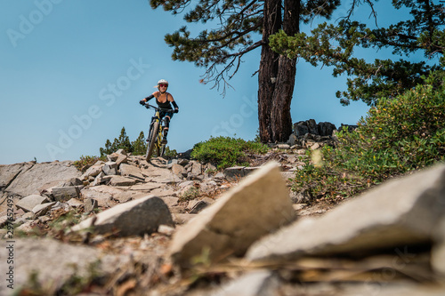Female mountain biker in rock garden