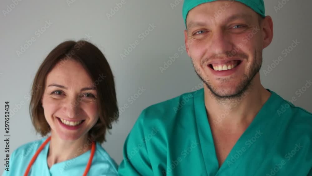 Male doctor and his female assitsent. Close portrait of smilling doctors, medicine and healthcare concept Male doctor and his female assitsent. Close portrait of smilling doctors, medicine and healthcare concept