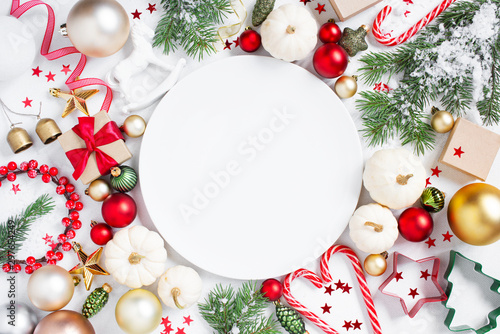 Christmas or New Year festive background with empty white plate and Christmas decoration