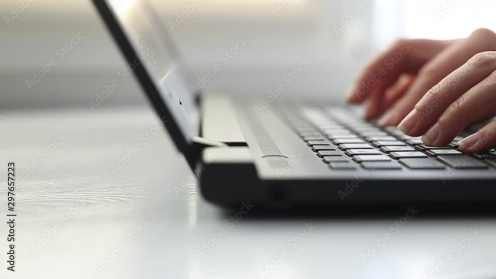 Close-up of female hands working on a laptop keyboard. Close-up of female hands working on a laptop keyboard.