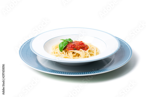 Original Italian Spaghetti with fresh tomato sauce and fresh basil. White wood table background.