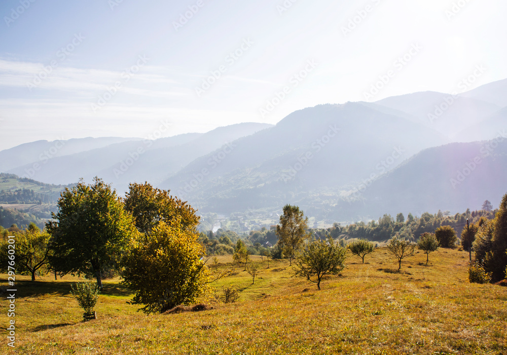 Fototapeta premium Beautiful autumn mountain forest landscape. Clouds over the rocks.