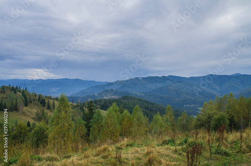 Beautiful autumn mountain forest landscape. Clouds over the rocks. © Payllik