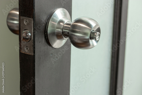 Stainless Steel Door knob with Wooden and Frosted Glass Door © aopsan