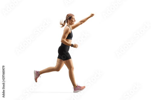 Fit young woman running with raised arm