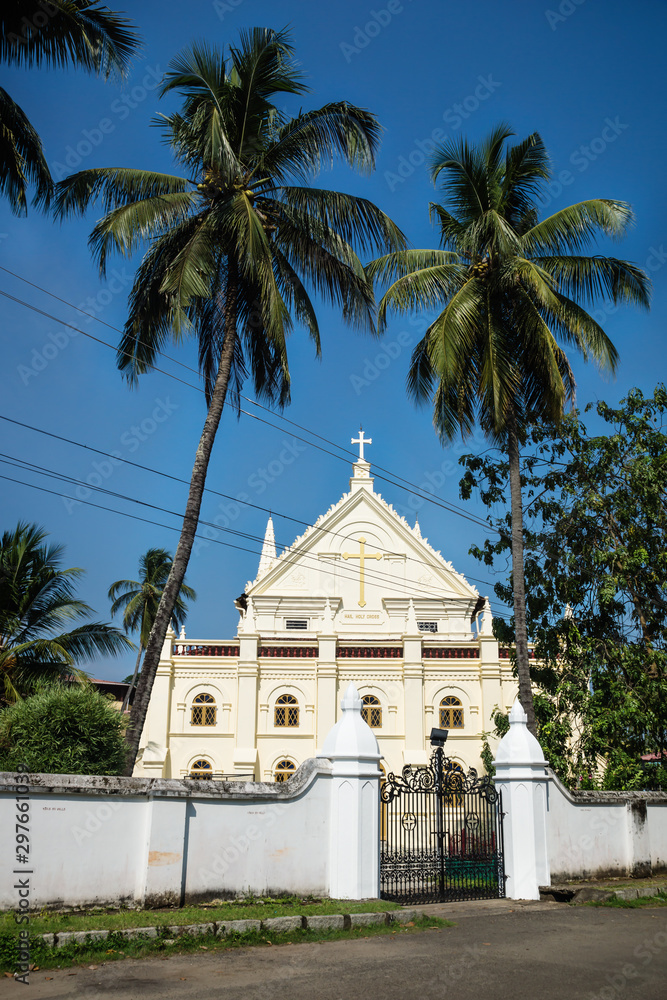 Santa Cruz Cathedral Basilica white colonial church with high palm trees in Kochi, Kerala, India