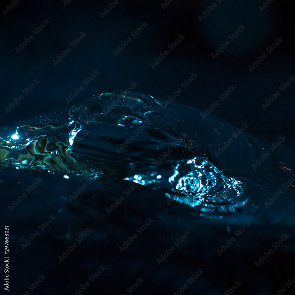 water splashes on a dark background water splashes on a dark background