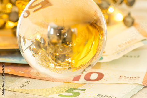 Fotografie Glass ball with Euro banknotes