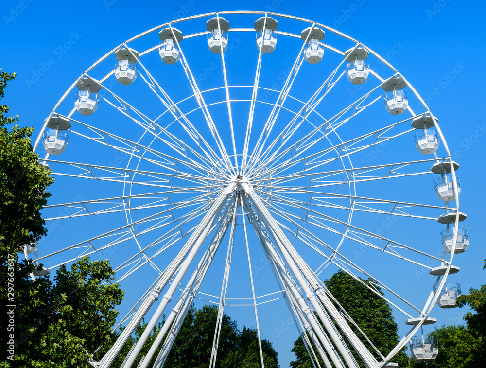 Fototapeta premium White ferris wheel on blue clear sky
