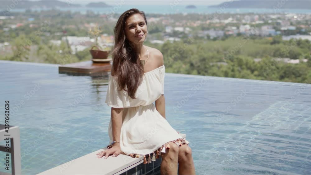 Attractive woman having fun while resting beside swimming pool in hotel Attractive woman having fun while resting beside swimming pool in hotel