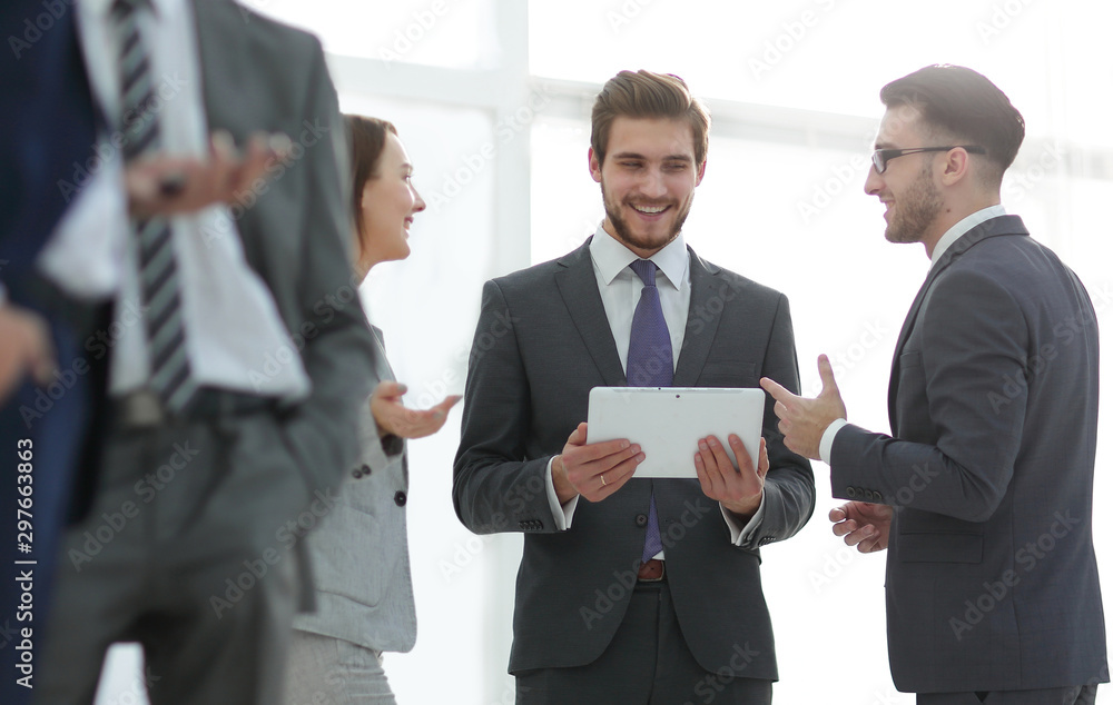 Happy business colleagues in modern office using tablet Happy business colleagues in modern office using tablet