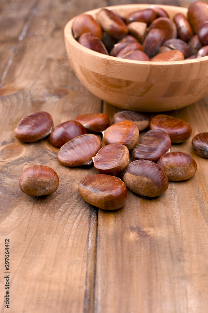 Cup of chestnuts on a wooden background. Autumn harvest and ripe fruits. Free space for text. Cup of chestnuts on a wooden background. Autumn harvest and ripe fruits. Free space for text.
