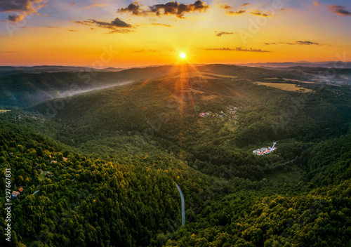 Aerial view of green valley during colorful sunset