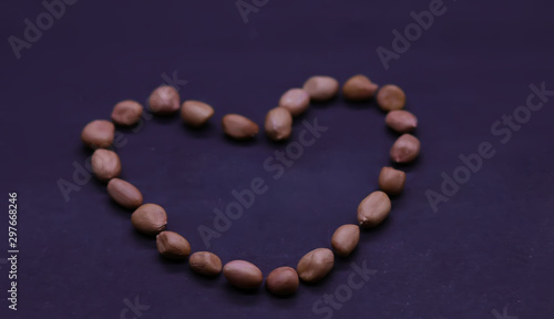 Beautiful heart of the peanuts on the black background. Valentine's day. Symbol of lovers. Retro style.