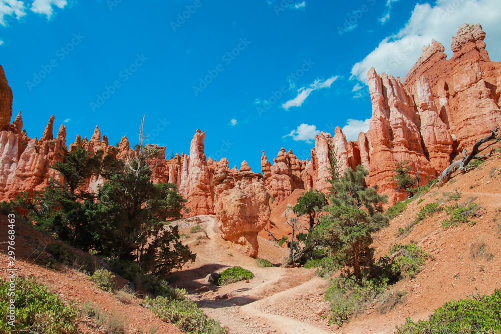 Beautiful Bryce Canyon National Park in Utah, USA. Orange rocks, blue sky. Giant natural amphitheaters and hoodoos formations. Great panoramic views from vista points and breathtaking adventure.