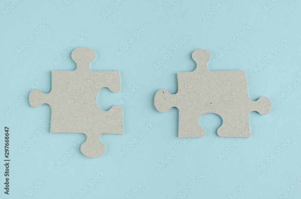 Obraz premium Gray puzzles composition on blue background. Flat lay