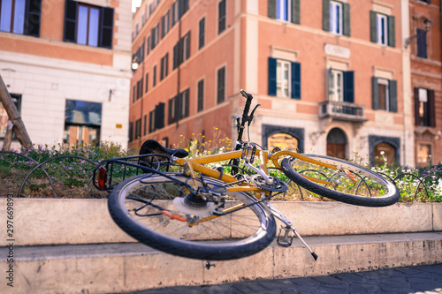 Beautiful italian street with abandoned yellow bicycle, vintage style. Italian architecture, Roman town square