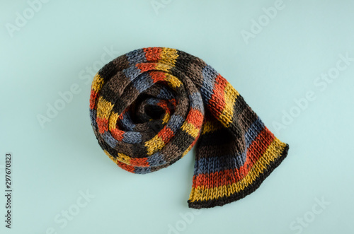 Woolen scarf composition on blue background. Flat lay.