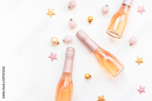 Bottles of rose champagne wine on white background