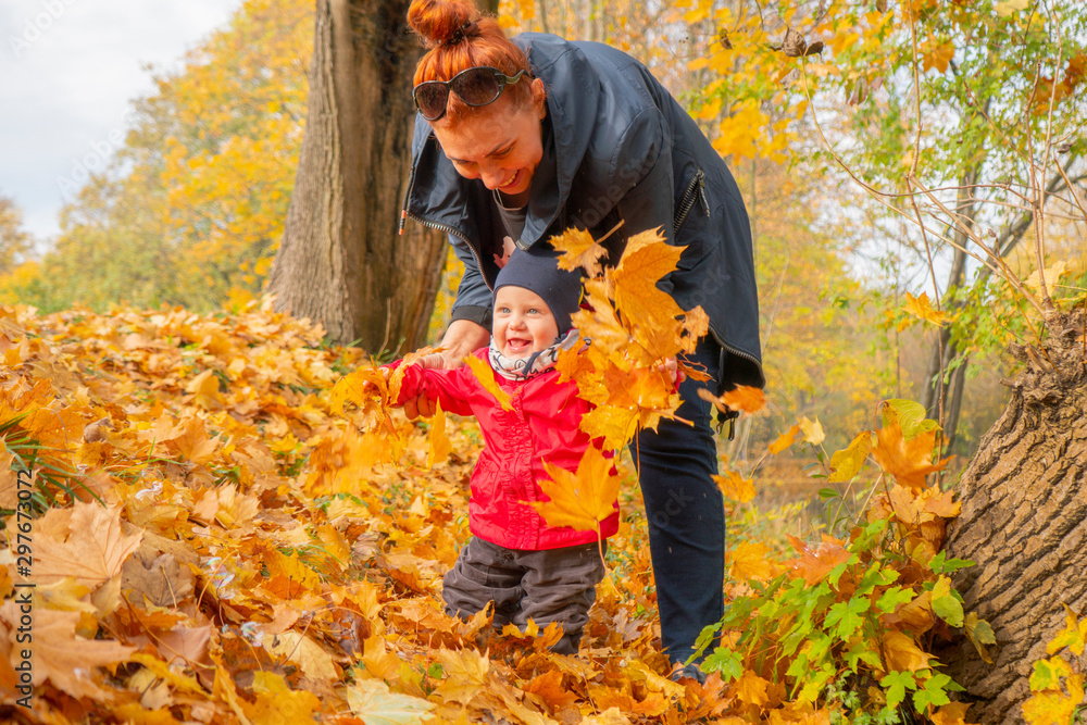 autumn.a mother and her child walking in autumn Park and smiling autumn.a mother and her child walking in autumn Park and smiling