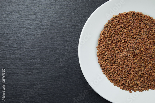 buckwheat in a white plate on a dark background