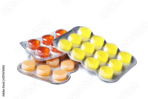 Many Blisters with color cough drops isolated on a white background.