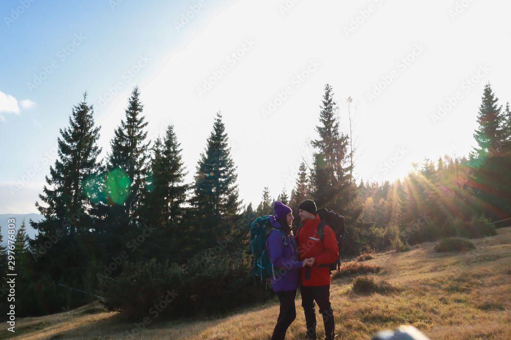Girl and man hikers in mountains. Travel backpacks and clothing. Campaign. Ukrainian Carpathian Mountains. Traveling in Ukraine.Couple
