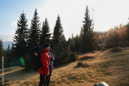 Girl and man hikers in mountains. Travel backpacks and clothing. Campaign. Ukrainian Carpathian Mountains. Traveling in Ukraine.Couple