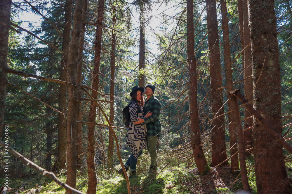 Girl and man hikers in mountains. Nice clothes.Campaign. Ukrainian Carpathian Mountains. Traveling in Ukraine.Couple in love