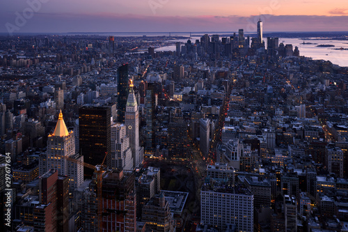 New York City aerial view of the skyscrapers of Manhattan at twilight. The view includes Lower Manhattan, Union Square, Midtown, New York Harbor, and Brooklyn. NY, USA