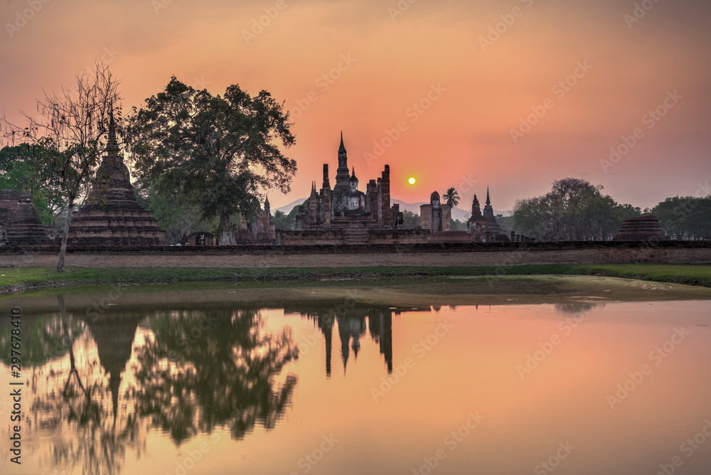 Wat Maha That temple at Sunset in Sukhothai historical park, A World Heritage site, in Central Thailand	